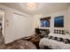 Simple bedroom with a desk and bed, featuring a window with a view at 6483 S Prince St, Littleton, CO 80120
