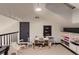 Bonus room with vaulted ceiling, desk and chair, storage shelves, and natural light at 6483 S Prince St, Littleton, CO 80120