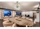 Open-concept dining area with designer lighting adjacent to the living room at 6483 S Prince St, Littleton, CO 80120
