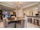 Cozy dining room with a chandelier and view into the living room at 6483 S Prince St, Littleton, CO 80120