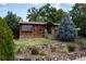 Charming home with a stone facade, well-maintained landscaping, and inviting entrance at 6483 S Prince St, Littleton, CO 80120