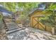 Garage with wooden door, set back off the street with stone stairs leading to the main house at 6483 S Prince St, Littleton, CO 80120