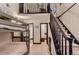 Open hallway with dark trimmed stairs, a bunkbed room and neutral carpeting at 6483 S Prince St, Littleton, CO 80120