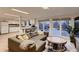 Open floor plan with large living room opening to kitchen with patio access and natural light at 6483 S Prince St, Littleton, CO 80120