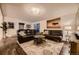 Inviting living room features leather sofas, stylish rug, and modern decor at 6483 S Prince St, Littleton, CO 80120