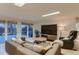 Spacious living room with a large sectional sofa, tile floors, and natural light from the patio at 6483 S Prince St, Littleton, CO 80120