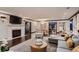 Elegant living room features a fireplace, modern chandelier, and dark hardwood floors at 6483 S Prince St, Littleton, CO 80120