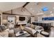 Spacious living room with high ceilings, modern decor, and an open flow to the kitchen and dining areas at 6483 S Prince St, Littleton, CO 80120
