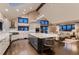 Open-concept kitchen and living area with vaulted ceilings, skylight, and contemporary design elements at 6483 S Prince St, Littleton, CO 80120