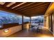 Covered outdoor deck with wood planking, a dining table and a view at 6483 S Prince St, Littleton, CO 80120