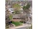 An aerial view shows a house with a manicured lawn and mature trees at 11609 Fowler Dr, Northglenn, CO 80233