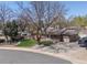Aerial view of a charming brick home with a manicured lawn and mature trees at 11609 Fowler Dr, Northglenn, CO 80233