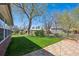 Backyard featuring green grass, a red brick patio, and a view of neighborhood homes at 11609 Fowler Dr, Northglenn, CO 80233