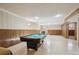 This basement features wood paneling, a pool table, and a fireplace at 11609 Fowler Dr, Northglenn, CO 80233