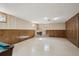 This basement features wood paneling, a fireplace, and a smooth floor at 11609 Fowler Dr, Northglenn, CO 80233