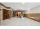 This basement features wood paneling, a pool table, and a bar at 11609 Fowler Dr, Northglenn, CO 80233