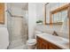 Modern bathroom with glass-enclosed shower, vanity with sink, and tiled floors at 11609 Fowler Dr, Northglenn, CO 80233