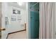 Small retro bathroom featuring a blue tiled shower with a white curtain at 11609 Fowler Dr, Northglenn, CO 80233