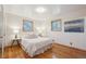 Inviting bedroom with hardwood floors, ample natural light, and comfortable decor at 11609 Fowler Dr, Northglenn, CO 80233
