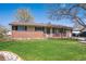 Charming single-story home features a well-maintained lawn and brick accents at 11609 Fowler Dr, Northglenn, CO 80233