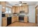 Updated kitchen featuring stainless steel appliances, light wood cabinetry, and tile backsplash at 11609 Fowler Dr, Northglenn, CO 80233