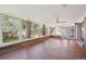 This sunroom features hardwood floors, many windows, and a view of the backyard at 11609 Fowler Dr, Northglenn, CO 80233
