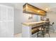 Finished basement featuring a bar with gold accents and seating for entertaining guests at 3709 S Fairplay Way, Aurora, CO 80014
