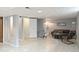 Spacious basement living room with neutral tones, tiled floors, and comfortable seating area at 3709 S Fairplay Way, Aurora, CO 80014