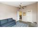 Bedroom with blue loveseat and view of the staircase at 3709 S Fairplay Way, Aurora, CO 80014