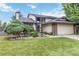 Charming two-story home with an attached garage, lush lawn, and beautifully landscaped front yard at 3709 S Fairplay Way, Aurora, CO 80014