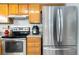 Kitchen featuring stainless steel appliances and ample cabinet space at 3709 S Fairplay Way, Aurora, CO 80014