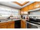 Charming kitchen with stainless steel appliances, tile backsplash, and ample natural light at 3709 S Fairplay Way, Aurora, CO 80014