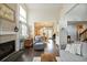 Bright living room with tall ceilings, fireplace, and open view to the dining area at 3709 S Fairplay Way, Aurora, CO 80014
