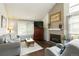 Comfortable living room with brick fireplace, large window, and neutral decor at 3709 S Fairplay Way, Aurora, CO 80014