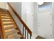 Carpeted staircase with wood railing leading to the upper level of the home at 3709 S Fairplay Way, Aurora, CO 80014