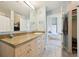 Bathroom with double sinks and a view to the bedroom at 5677 S Park Pl # 311A, Greenwood Village, CO 80111