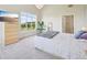 Bright bedroom boasts large window, TV, patterned duvet, and neutral carpeting at 5677 S Park Pl # 311A, Greenwood Village, CO 80111
