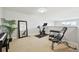 Bonus room features exercise equipment, piano, and natural light at 5677 S Park Pl # 311A, Greenwood Village, CO 80111