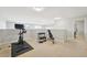 Spacious bonus room with exercise bike and weights set at 5677 S Park Pl # 311A, Greenwood Village, CO 80111