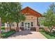 Inviting entrance features peaked roof, wood supports, and brick detailing at 5677 S Park Pl # 311A, Greenwood Village, CO 80111