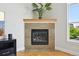 Close up shot of the fireplace which features a stone surround and a wooden mantle at 5677 S Park Pl # 311A, Greenwood Village, CO 80111