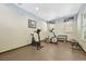 A community gym with an elliptical, bike, weight rack, and bench at 5677 S Park Pl # 311A, Greenwood Village, CO 80111