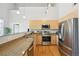 Modern kitchen with stainless steel appliances, granite countertops, and bright wooden cabinets at 5677 S Park Pl # 311A, Greenwood Village, CO 80111