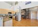Modern kitchen with stainless steel appliances and an adjoining living area with a spiral staircase at 5677 S Park Pl # 311A, Greenwood Village, CO 80111
