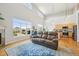 Bright living room with high ceilings, large windows, hardwood floors, and a modern fireplace at 5677 S Park Pl # 311A, Greenwood Village, CO 80111