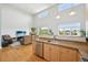Open-concept kitchen and living room with hardwood floors and a charming fireplace at 5677 S Park Pl # 311A, Greenwood Village, CO 80111