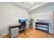Office with modern desk, dual monitors, shelving, and stylish wood floors at 5677 S Park Pl # 311A, Greenwood Village, CO 80111