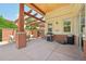 Outdoor grill area with pergola, featuring a barbecue grill, seating, and brick accents for community enjoyment at 5677 S Park Pl # 311A, Greenwood Village, CO 80111