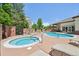 Attractive pool area with a hot tub, lounge chairs, and a covered pergola, perfect for relaxation and entertainment at 5677 S Park Pl # 311A, Greenwood Village, CO 80111