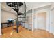 Bright room featuring a stylish black spiral staircase and a comfortable office area at 5677 S Park Pl # 311A, Greenwood Village, CO 80111